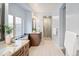 Stylish bathroom with double sinks, granite counters, tile flooring, and modern fixtures at 9715 E 33Rd Ave, Denver, CO 80238