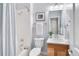 Bathroom features a shower with white tile, white vanity, and classic fixtures at 9715 E 33Rd Ave, Denver, CO 80238