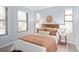 Cozy bedroom with multiple windows, warm lighting, and a comfortable bed with stylish bedding at 9715 E 33Rd Ave, Denver, CO 80238