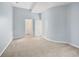 Light-blue bedroom with 2 doorways and light carpet at 9715 E 33Rd Ave, Denver, CO 80238