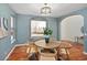 Stylish dining room with seating for four, an arched doorway and large windows with outside view at 9715 E 33Rd Ave, Denver, CO 80238