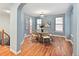 Inviting dining room with hardwood floors, modern chandelier, and natural light from the windows at 9715 E 33Rd Ave, Denver, CO 80238