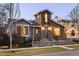 Beautiful stone-accented home with tower, front steps, small porch, and beautifully landscaped yard at 9715 E 33Rd Ave, Denver, CO 80238