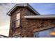 Close-up of stone tower showing architecture and a small balcony with wrought iron railing at 9715 E 33Rd Ave, Denver, CO 80238