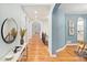 Hallway with archways, hardwood floors, neutral paint and staircase to the left at 9715 E 33Rd Ave, Denver, CO 80238