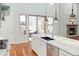 Spacious kitchen with island seating, gas range, access to outside patio and cozy fireplace at 9715 E 33Rd Ave, Denver, CO 80238