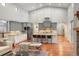 Spacious kitchen featuring grey cabinets, stainless steel appliances and hardwood floors at 9715 E 33Rd Ave, Denver, CO 80238