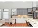 Spacious kitchen featuring modern cabinetry, stainless steel appliances, and a built-in desk area at 9715 E 33Rd Ave, Denver, CO 80238
