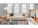 Stylish living room featuring a comfortable sofa, and modern decor, complemented by hardwood floors at 9715 E 33Rd Ave, Denver, CO 80238