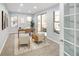 Bright home office featuring large windows, neutral decor, and access to the outdoor patio at 9715 E 33Rd Ave, Denver, CO 80238