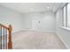 Open room with carpet, a single window and white door at 9715 E 33Rd Ave, Denver, CO 80238