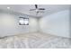 Finished basement space with neutral carpet, ceiling fan and recessed lights at 561 Saulsbury St, Lakewood, CO 80226