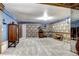 A finished basement space featuring classic decor, vintage furniture, and soft carpeting at 561 Saulsbury St, Lakewood, CO 80226