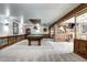 The finished basement features a pool table, brick accents, wood trim, and custom lighting at 561 Saulsbury St, Lakewood, CO 80226