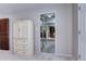 A bright bathroom is visible through the doorway, featuring a large soaking tub and tiled floors at 561 Saulsbury St, Lakewood, CO 80226