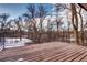 Wood deck with metal railing offers space to relax with a lovely nature view at 561 Saulsbury St, Lakewood, CO 80226