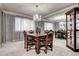 Formal dining room with antique-style table, large window and mirrored wall at 561 Saulsbury St, Lakewood, CO 80226