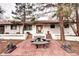 Charming exterior with brick patio and white brickwork, enhanced by tasteful landscaping at 561 Saulsbury St, Lakewood, CO 80226