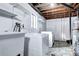 Functional laundry area with modern appliances and ample storage shelving at 561 Saulsbury St, Lakewood, CO 80226