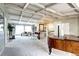 Bright living room with high ceilings, a grand piano, a fireplace, and large windows at 561 Saulsbury St, Lakewood, CO 80226