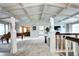 Open-concept living area with statues, high ceilings, hardwood floors, and fireplace at 561 Saulsbury St, Lakewood, CO 80226