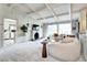 Open-concept living room featuring a cozy fireplace, large windows, and stylish furnishings at 561 Saulsbury St, Lakewood, CO 80226