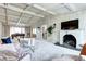 Living room showing fireplace, large windows, piano, and coffered ceilings at 561 Saulsbury St, Lakewood, CO 80226