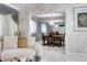 Living room view into mirrored dining room with chandelier and formal dining set at 561 Saulsbury St, Lakewood, CO 80226