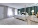 Bright main bedroom with four-poster bed, sheer curtains, and striped wallpaper at 561 Saulsbury St, Lakewood, CO 80226