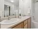 Bright bathroom with double sinks, spacious countertop, and essential toiletries, all illuminated by soft lighting at 12711 Colorado Blvd # H804, Thornton, CO 80241
