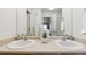 Bathroom featuring dual sinks, a large mirror, and plenty of counter space, ideal for a Gathering at 12711 Colorado Blvd # H804, Thornton, CO 80241