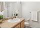 Well-lit bathroom featuring a single sink vanity, framed mirror, and a shower with glass doors at 12711 Colorado Blvd # H804, Thornton, CO 80241