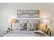 This primary bedroom features neutral decor, plush pillows, lamps and artwork at 12711 Colorado Blvd # H804, Thornton, CO 80241