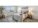 Cozy bedroom featuring a neutral color scheme, plush bedding, and large window for ample natural light at 12711 Colorado Blvd # H804, Thornton, CO 80241