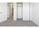 Bright bedroom featuring neutral carpet, closet with sliding doors, and white trim for a clean and airy aesthetic at 12711 Colorado Blvd # H804, Thornton, CO 80241