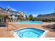 Resort-style community pool and hot tub with ample seating, surrounded by well-maintained landscaping and buildings at 12711 Colorado Blvd # H804, Thornton, CO 80241