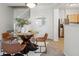 Dining area with round table, four chairs, modern lighting, and a view of the kitchen at 12711 Colorado Blvd # H804, Thornton, CO 80241