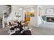 Open-concept dining area with wood floors, stylish table, and views into the adjacent kitchen with wood cabinets at 12711 Colorado Blvd # H804, Thornton, CO 80241