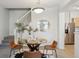 Bright dining area with modern table and chairs, staircase, and stainless steel appliances nearby at 12711 Colorado Blvd # H804, Thornton, CO 80241