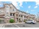 Exterior view of a condo building featuring stone accents, a parking lot, and manicured landscaping at 12711 Colorado Blvd # H804, Thornton, CO 80241