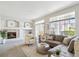 Bright living room with a modern fireplace, grey sofa, and access to a balcony through sliding glass doors at 12711 Colorado Blvd # H804, Thornton, CO 80241