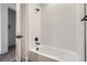 Modern bathroom featuring a white tiled shower and black hardware at 20588 E 63Rd Ave, Aurora, CO 80019