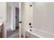 Modern bathroom featuring a white tiled shower and black hardware at 20588 E 63Rd Ave, Aurora, CO 80019