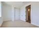 Bright bedroom with neutral carpet, white walls, closet with white doors, and modern trim at 20588 E 63Rd Ave, Aurora, CO 80019