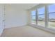 Bright, carpeted bedroom with large windows offering an expansive view at 20588 E 63Rd Ave, Aurora, CO 80019