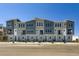 New townhome with mixed brick and stone facade and covered entryways at 20588 E 63Rd Ave, Aurora, CO 80019