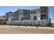Modern townhome complex featuring a mix of stone and gray siding for a contemporary look at 20588 E 63Rd Ave, Aurora, CO 80019