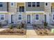 Townhome front entrance with stone facade, landscaped with decorative plants and gravel at 20588 E 63Rd Ave, Aurora, CO 80019