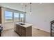 Open kitchen with island, stainless steel dishwasher and three large windows at 20588 E 63Rd Ave, Aurora, CO 80019