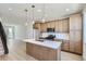 Spacious kitchen with modern appliances, island, and open layout to living area at 20588 E 63Rd Ave, Aurora, CO 80019